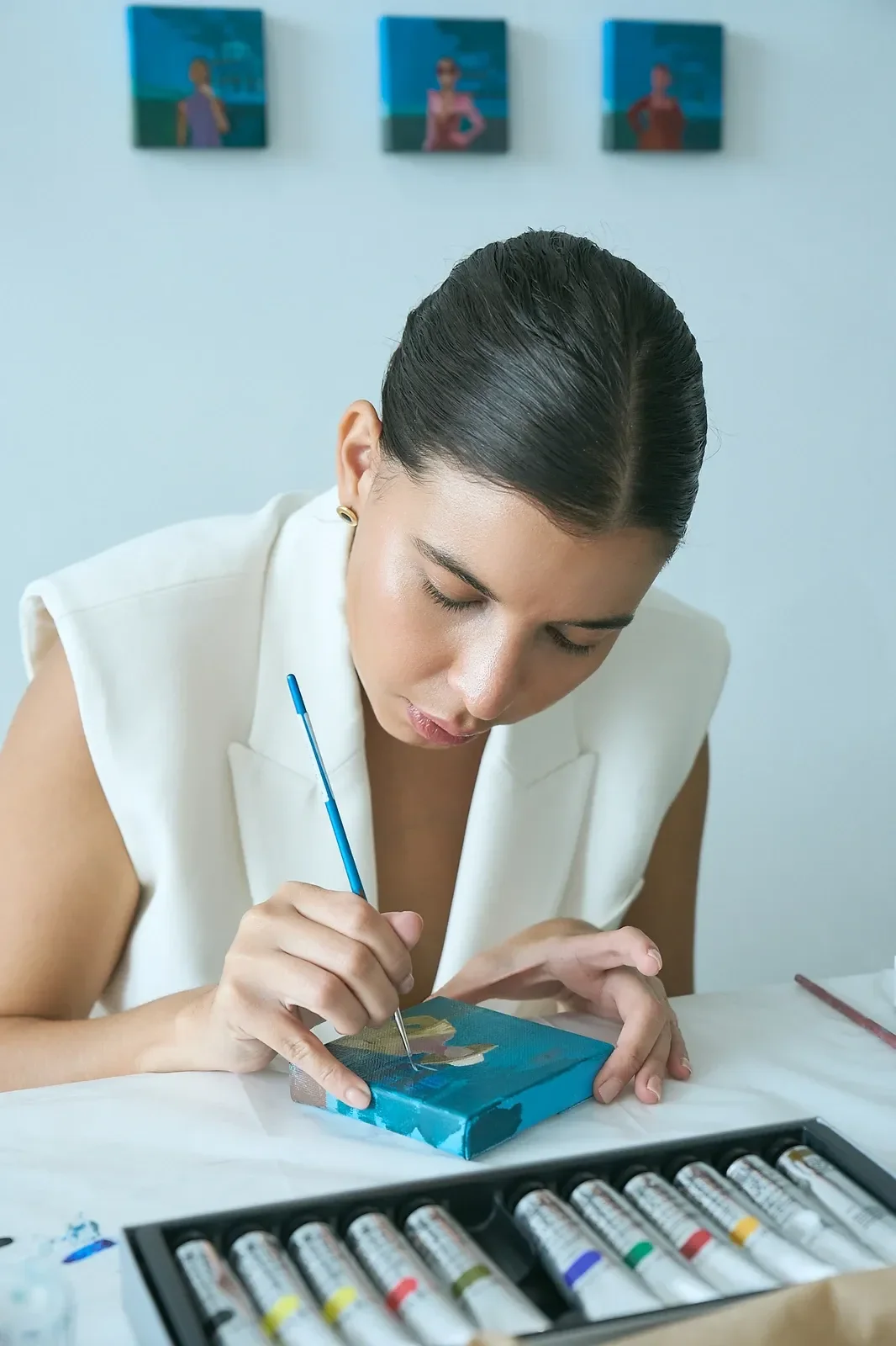 Angie Mueller painting in her studio
